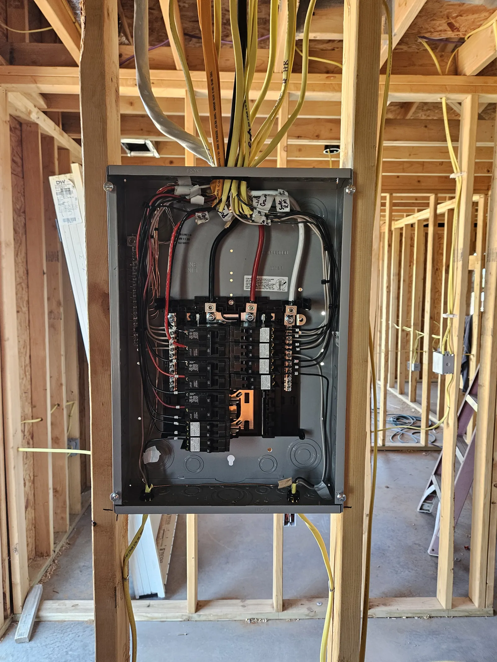 New construction electrical panel install with Romex feeds